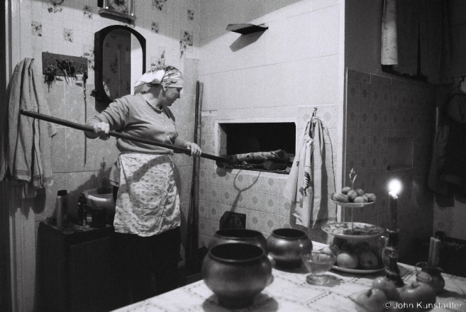 3b.Placing Wood at back of Stove, Kuts'tsja, Tsjerablichy 2017, 2017004- (F1100006